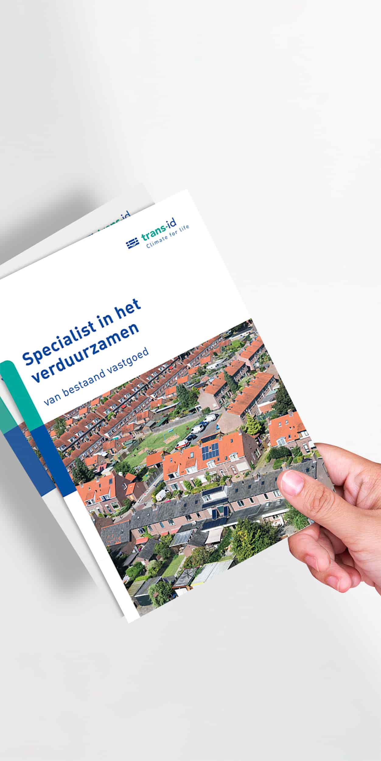 Dit is een afbeelding van de brochure van Trans-id. Op de afbeelding is een hand te zien die de brochure vasthoudt, hier is de cover te zien.